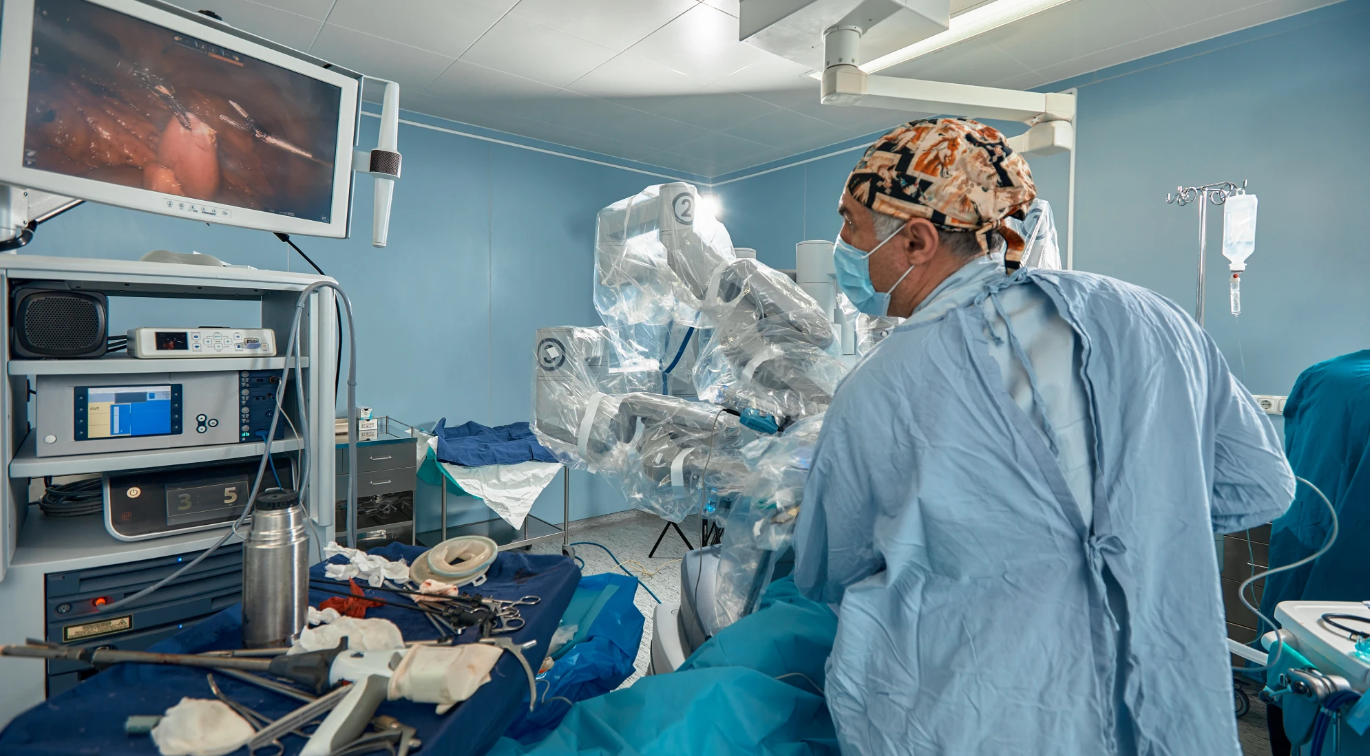 Surgeon performs robot-assisted procedure in operating room